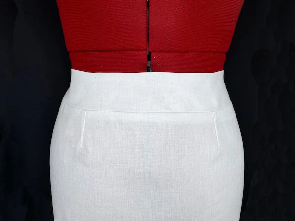 Cotton pencil skirt with a shaped waistband.