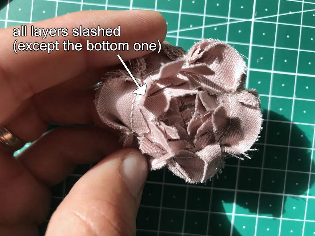 All layers of the flower applique are slashed to create the centre of the flower.