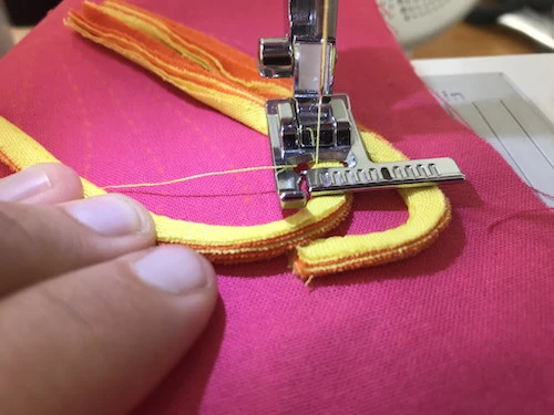 Sewing bent part of butterfly applique.