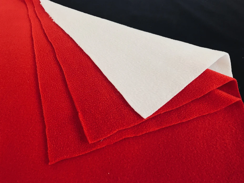 Red and white anti pilling 100% polyester fleece fabric.