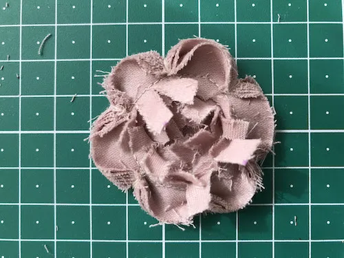 Faux-chenille style flower before cutting off excess stripes of fabric.