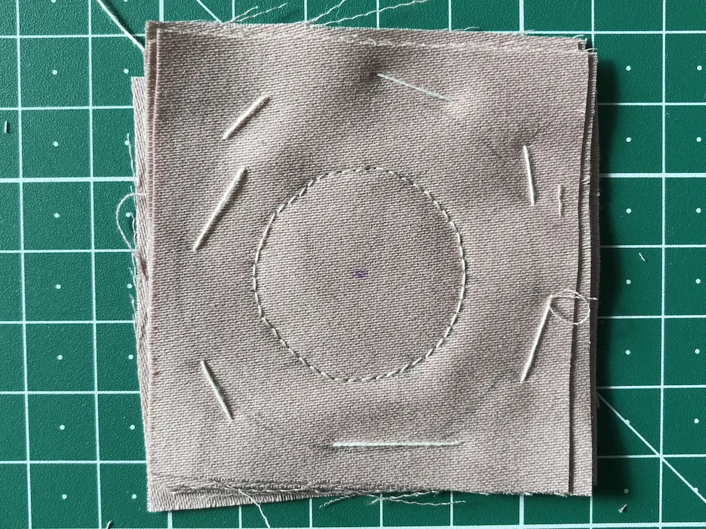 Stack of cotton fabrics basted and sewn together.