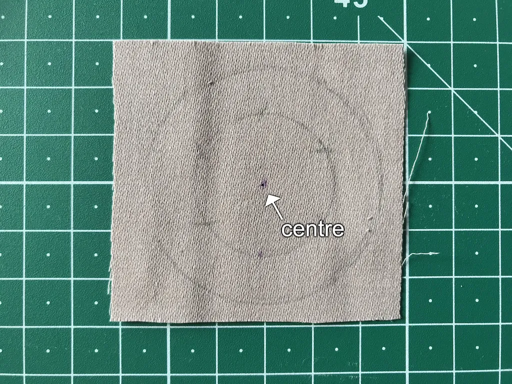 Cotton fabric rectangle with marked center.