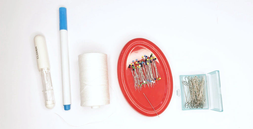 Tools needed to gather fabric with a cord and zig zag stitch.