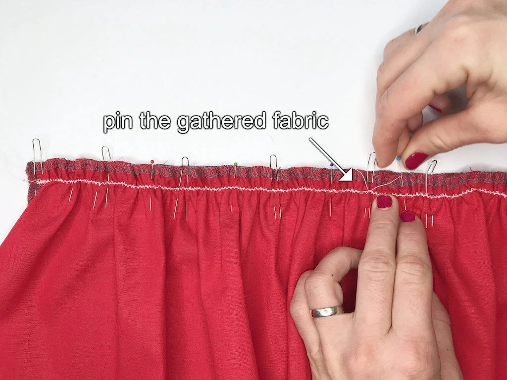 Fixing one end of basting thread to gathered fabric.