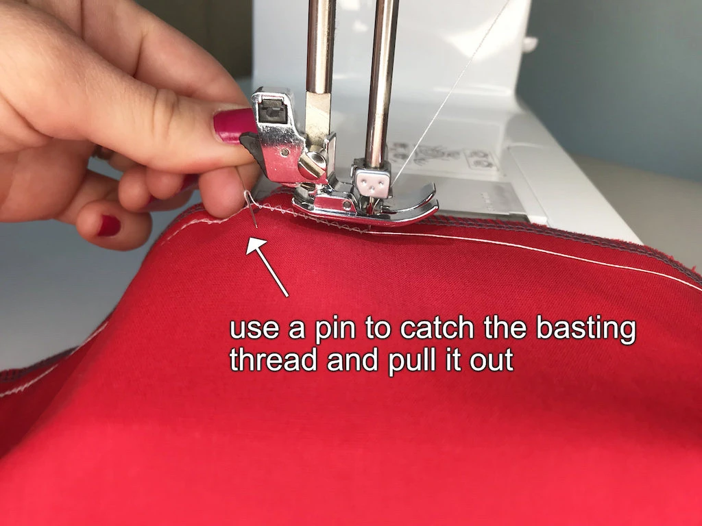 Pulling the basting thread with a classic pin.