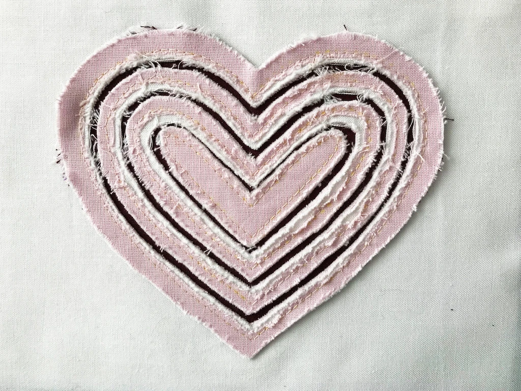 Rubbed stitch and slash heart applique. Rubbing was use to achieve a more interesting look.