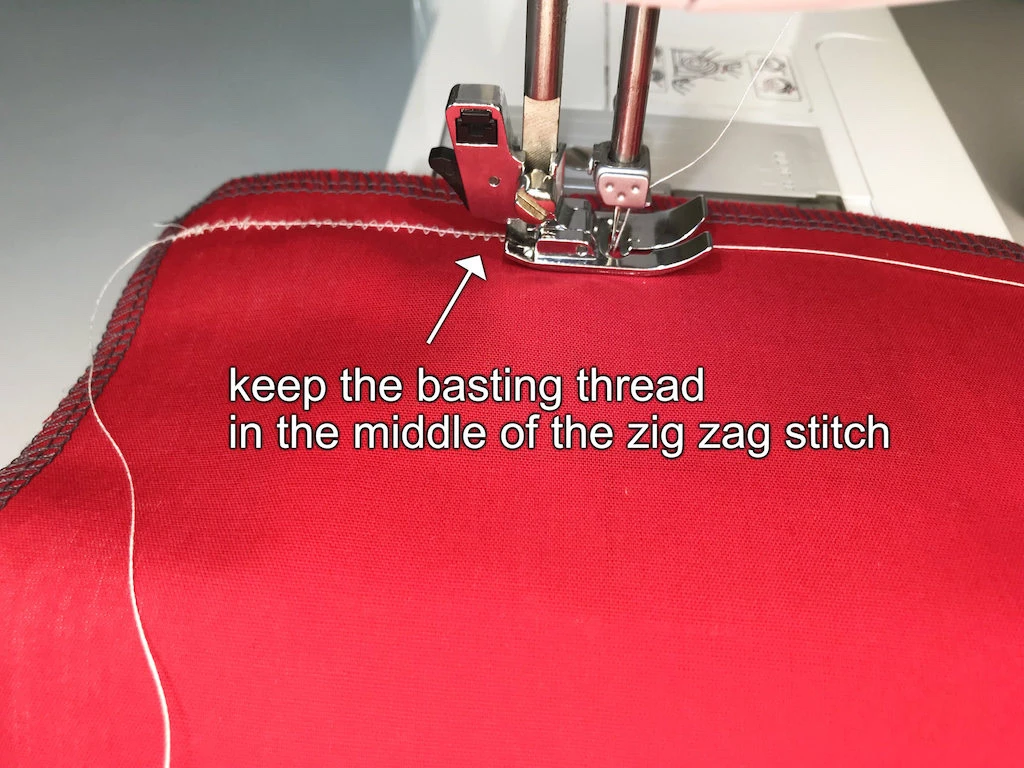 Sewing zig-zag stitch over the basting thread.