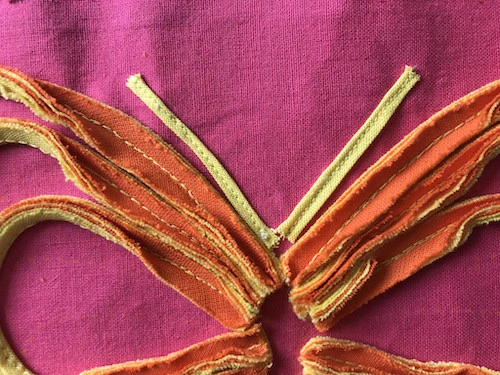 Butterfly antennae sewn to base fabric.