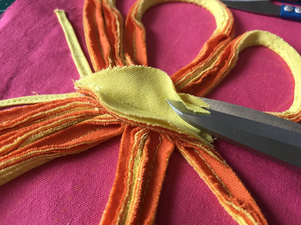 Shaping butterfly body with scissors and cutting of extra fabric.