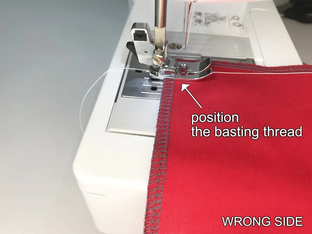 Basting thread prepared to be sewn with a medium width and length zig zag stitch.
