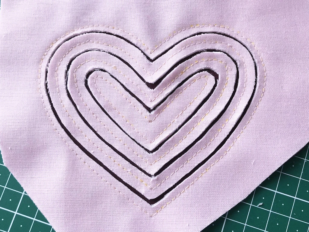 Cut out lines of stacked fabric.