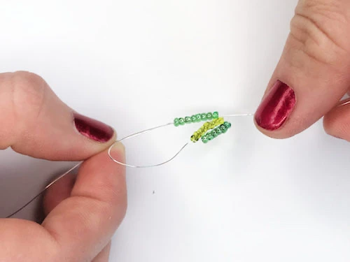 Looping dark green beads.