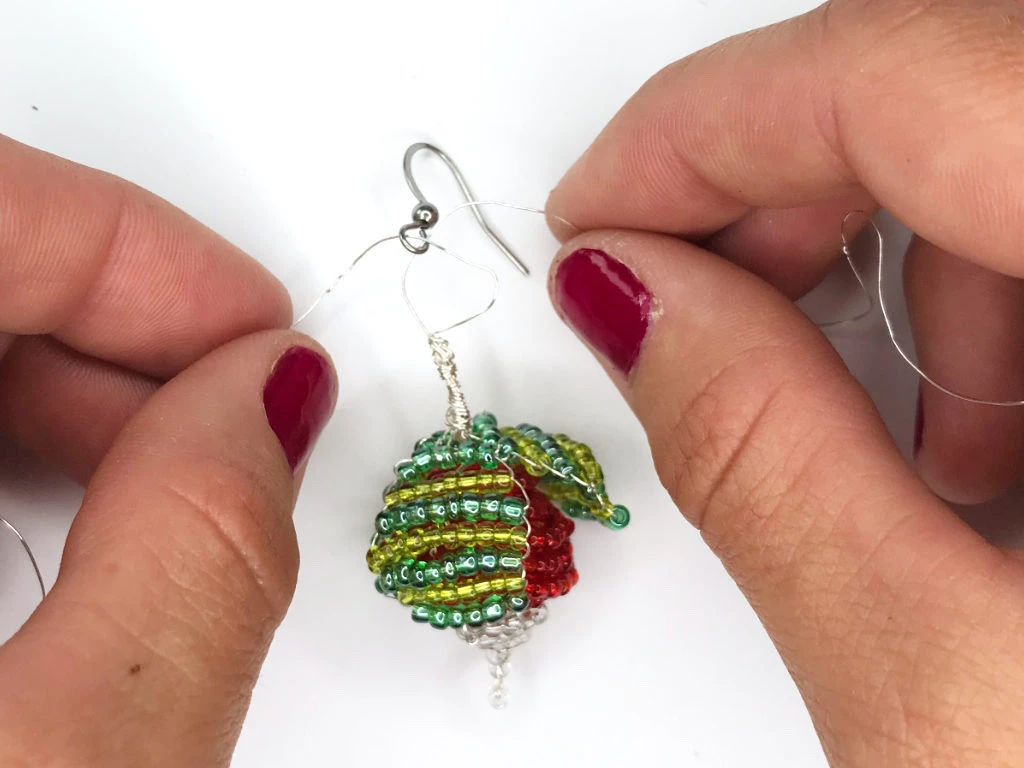Fixing a radish earring to an earring hook.