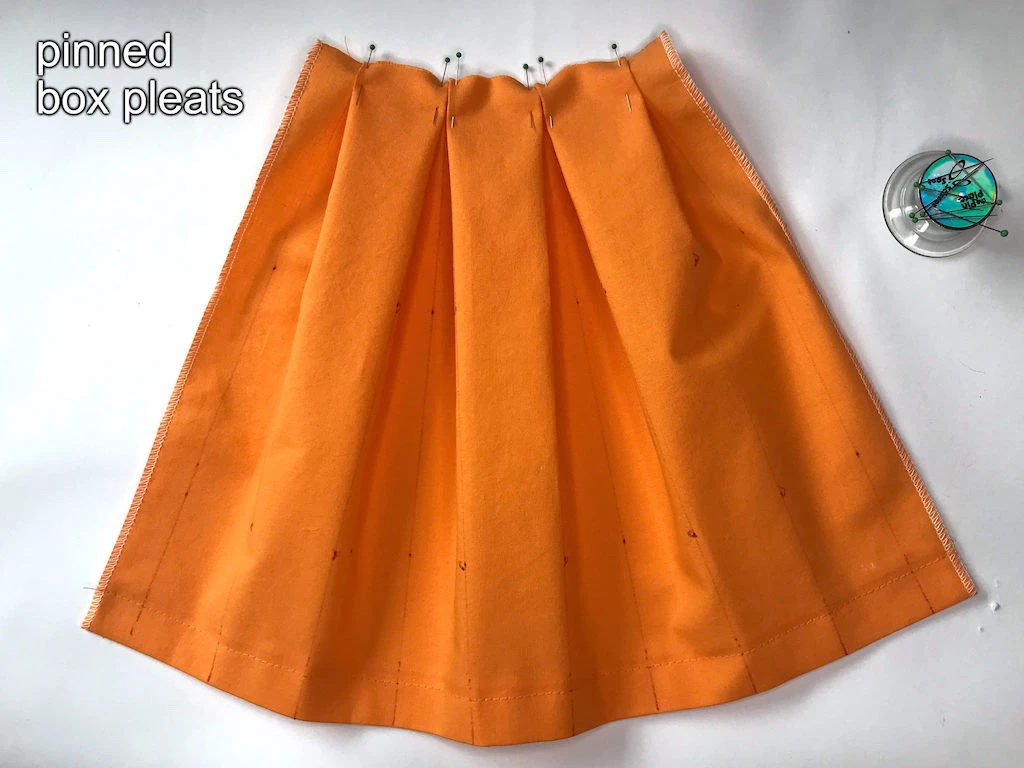 Pinned fabric with box pleats.