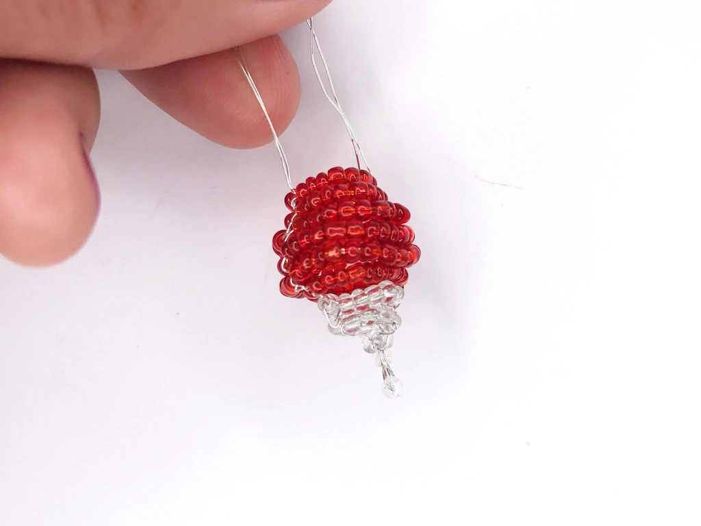 Beaded radish prepared to complete Luna's earrings.