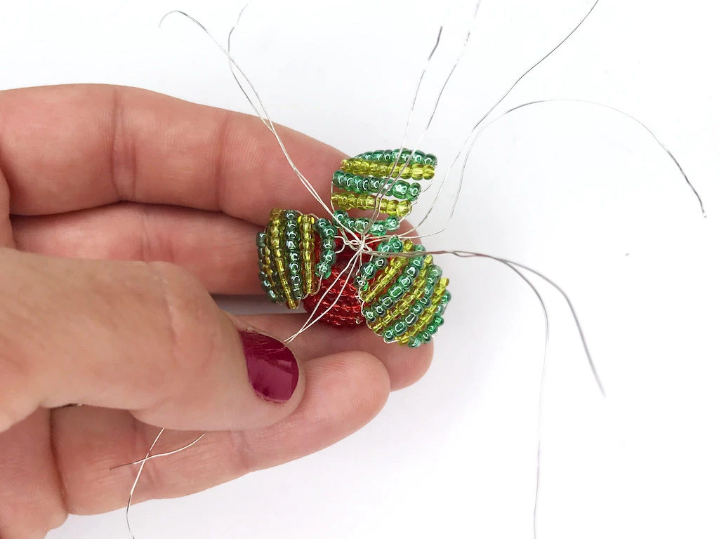 Attaching leaves to a radish to complete Luna Lovegood earrings.