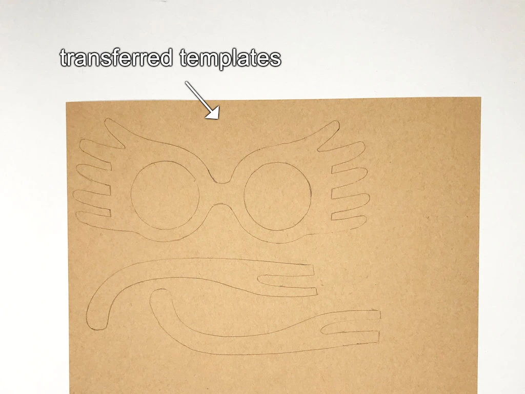 Individual parts of Luna Lovegood glasses on kraft paper.